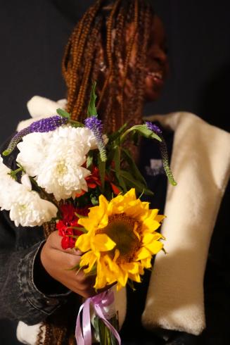 Photograph of student with their flower bouquet 