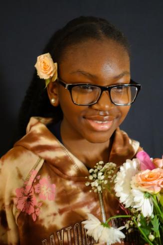 Photograph of student with their flower bouquet 