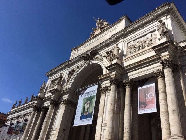 Photograph of facade of historic building with banners