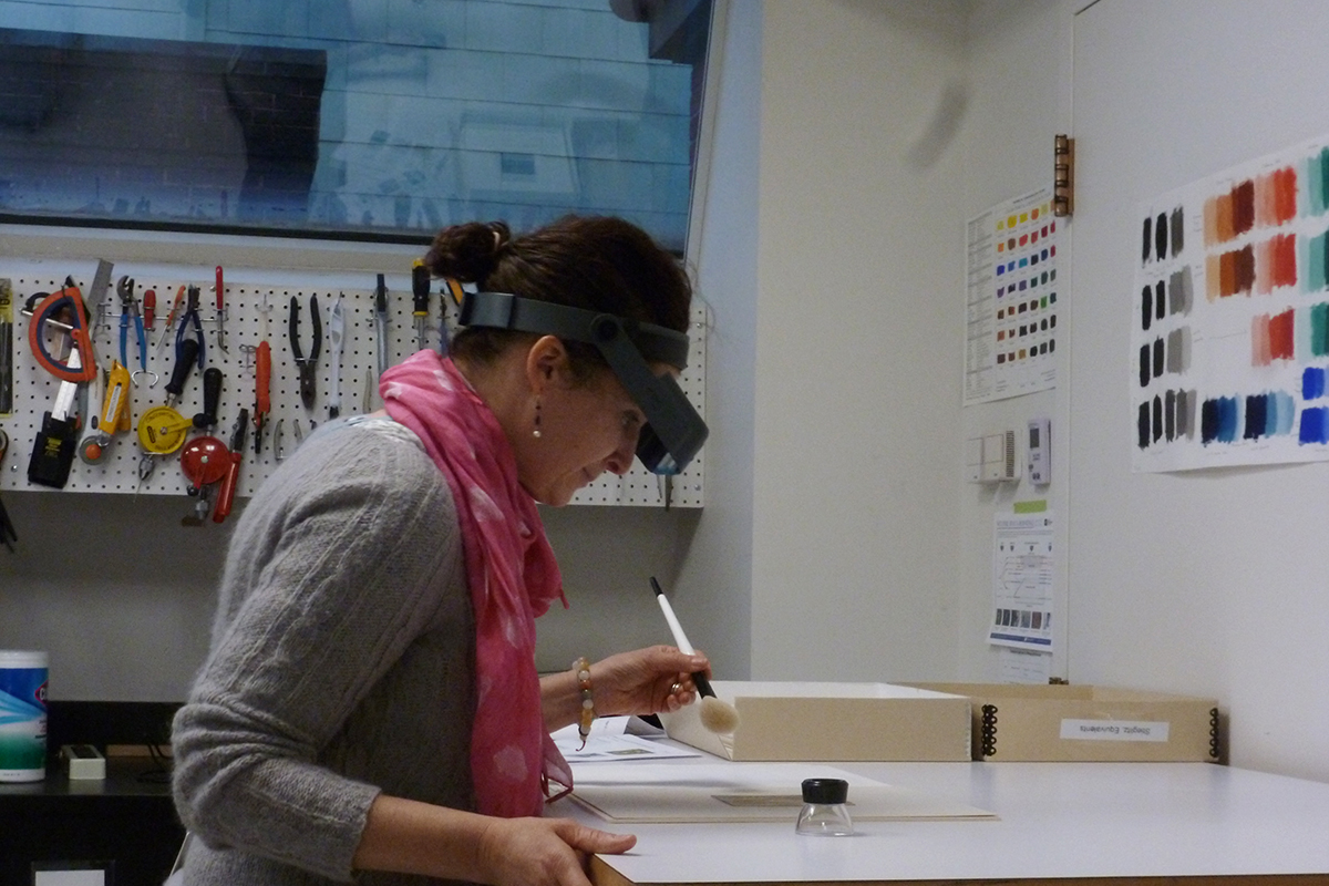 Photograph of a conservator working on a photograph